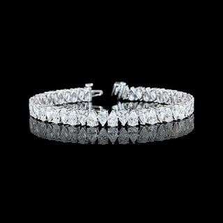 Pear-shaped lab-grown diamond tennis bracelet with 13 carats total weight in white gold, featuring alternating diamond design.