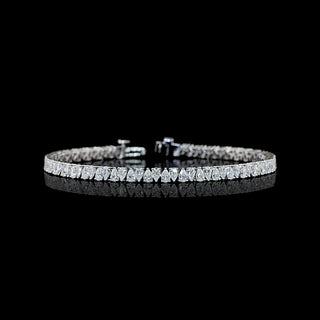 Pear-shaped lab grown diamond tennis bracelet in 14k white gold, with 6-pointer pear diamonds set vertically in alternating directions, prong setting, 5 carats total.