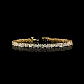 Pear-shaped lab grown diamond tennis bracelet in 14k yellow gold, with 6-pointer pear diamonds set vertically in alternating directions, prong setting, 5 carats total.