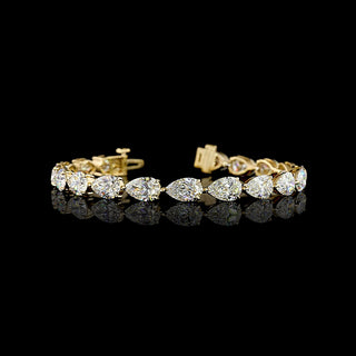 East-West Pear-shaped lab grown diamond tennis bracelet in 14k yellow gold, prong setting, 18 carats total, with 1 carat each pear diamonds.