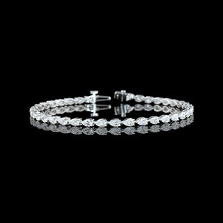 East-West pear-shaped lab-grown diamond tennis bracelet with 4 carats total weight in white gold, featuring 10-point diamonds.