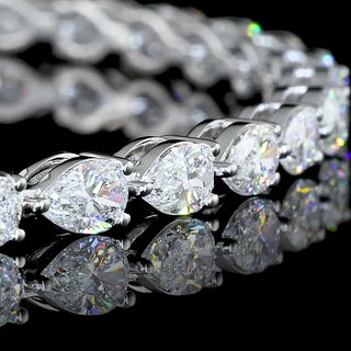 Lab-grown diamond tennis bracelet with 4 carats total weight featuring east-west pear-shaped diamonds in white gold setting.