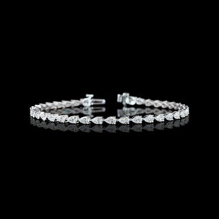 East-west pear shaped lab grown diamond tennis bracelet in 14k white gold prong setting, 4 carats total. 