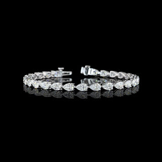 East-West Pear-shaped lab grown diamond tennis bracelet in 14k white gold, prong setting, 8 carat total weight, with 30 to 33-pointer diamonds.
