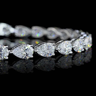 Close-up of East-West Pear-shaped lab grown diamond tennis bracelet in 14k white gold, with 33-pointer diamonds in a prong setting.