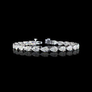 East-West Pear-shaped lab grown diamond tennis bracelet in 14k white gold, prong setting, 12 carats total, with 50-pointer diamonds.
