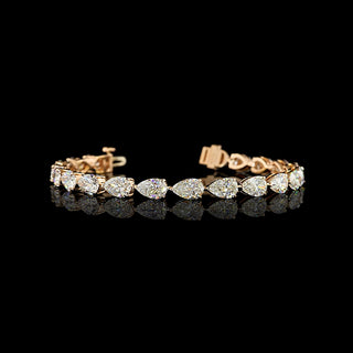 East-West Pear-shaped lab grown diamond tennis bracelet in 14k rose gold, prong setting, 14 carats total, with 70-pointer diamonds.