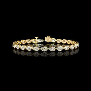 East-West Pear-shaped lab grown diamond tennis bracelet in 14k yellow gold bezel setting, 6 carats total, with 20-pointer diamonds.