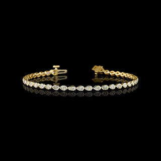 East-West Pear-shaped lab grown diamond tennis bracelet in 14k yellow gold bezel setting, 2 carats total, with 5-pointer diamonds.