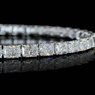 Close-up of East-West Radiant lab grown diamond tennis bracelet in 14k white gold claw prong setting.