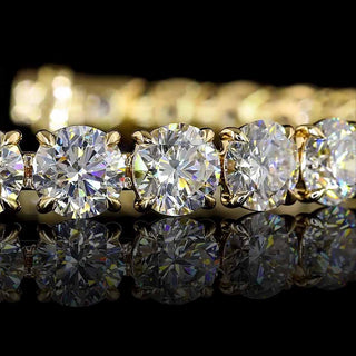 Gold tennis bracelet with round lab-grown diamonds totaling 27 carats, featuring 27 round diamonds on a 7-inch chain.