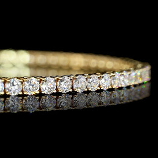 Yellow gold tennis bracelet featuring 3 carats total weight of round lab-grown diamonds in a 7-inch design.