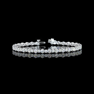 Alternating round lab-grown diamond tennis bracelet with 4.85cttw on a 7-inch white gold chain featuring sparkling diamonds.