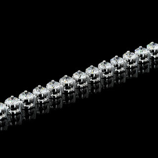 Round lab-grown diamond tennis bracelet with 5 carats total weight and three-prong settings in white gold, featuring 10-point diamonds.