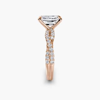 Twisted pavé engagement ring setting in rose gold showing the twisted band profile, with an emerald-cut lab grown center diamond. || #metal_rose gold #diamond shape_emerald