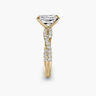 Twisted pavé engagement ring setting in yellow gold showing the twisted band profile, with an emerald-cut lab grown center diamond. || #metal_yellow gold #diamond shape_emerald