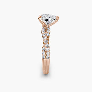 Twisted pavé engagement ring setting in rose gold showing the twisted band profile, with a heart-shaped lab grown center diamond. || #metal_rose gold #diamond shape_heart