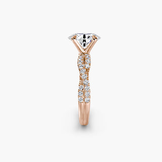Twisted pavé engagement ring setting in rose gold showing the twisted band profile, with an oval-cut lab grown center diamond. || #metal_rose gold #diamond shape_oval