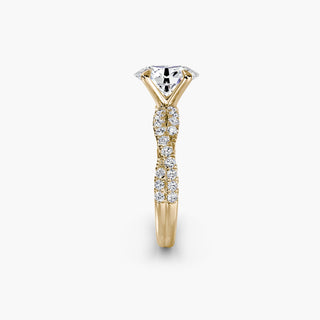 Twisted pavé engagement ring setting in yellow gold showing the twisted band profile, with an oval-cut lab grown center diamond. || #metal_yellow gold #diamond shape_oval