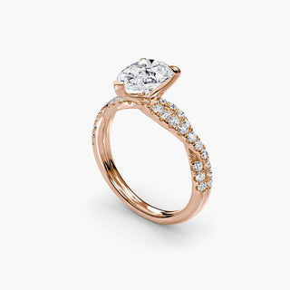 Twisted pavé engagement ring setting in rose gold with a pear-shaped lab grown center diamond and twisted pavé diamond band, three-quarter view. || #metal_rose gold #diamond shape_pear