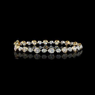Round lab grown diamond station bracelet with alternating size round diamonds in a two tone 14k white and yellow gold bezel setting, 5.5 carats total. || #total carat weight_5.5