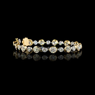 Round lab grown diamond station bracelet with alternating size round diamonds in a two tone 14k white and yellow gold bezel setting, 10.5 carats total. || #total carat weight_10.75