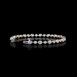 Round lab grown diamond station bracelet with alternating size round diamonds in a two tone 14k white and yellow gold bezel setting, 3 carats total. || #total carat weight_3