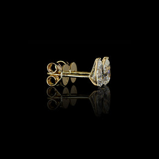 Video of 0.50 carat Pear-shaped lab grown diamond stud earrings in 14k yellow gold, martini setting, 1 carat total pear studs.