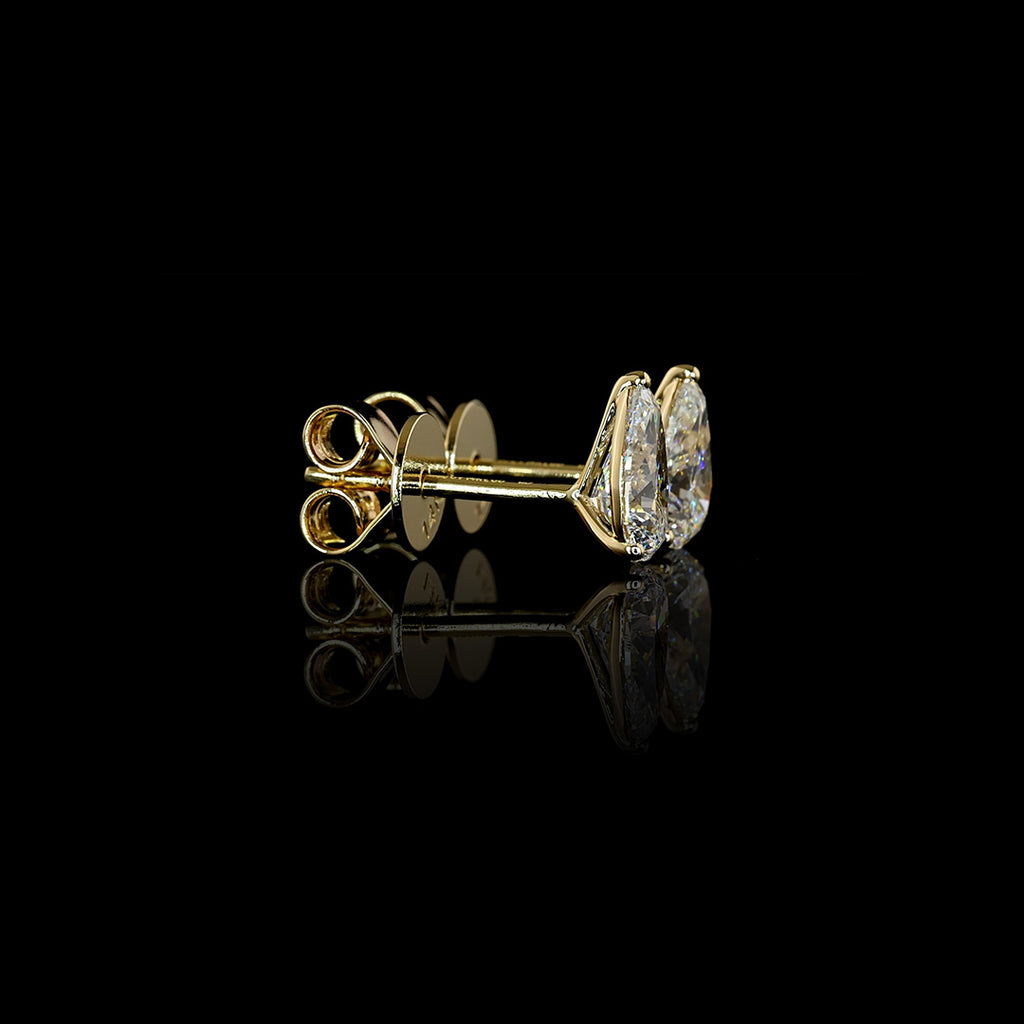 Video of 0.50 carat Pear-shaped lab grown diamond stud earrings in 14k yellow gold, martini setting, 1 carat total pear studs.