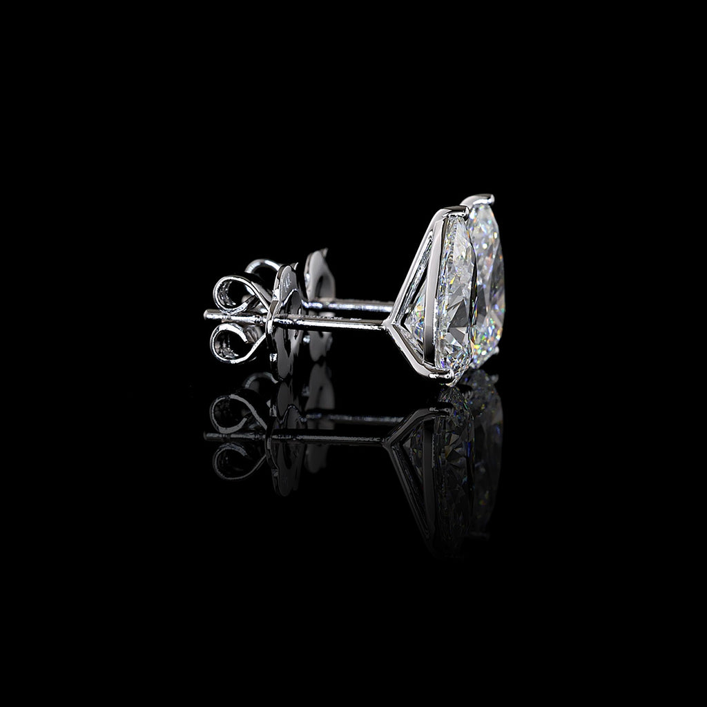 Video of of Pear-shaped lab grown diamond stud earrings in 14k white gold, 3-prong martini setting, 3 carats total (1.5 carats each), showing setting from multiple angles. || #total carat weight_3
