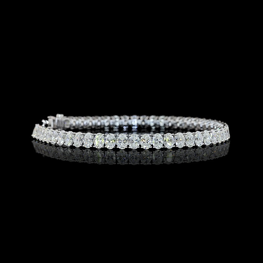 Video of Oval lab grown diamond tennis bracelet with 25-pointer diamonds in a 14k white gold prong setting, 12 carats total. 