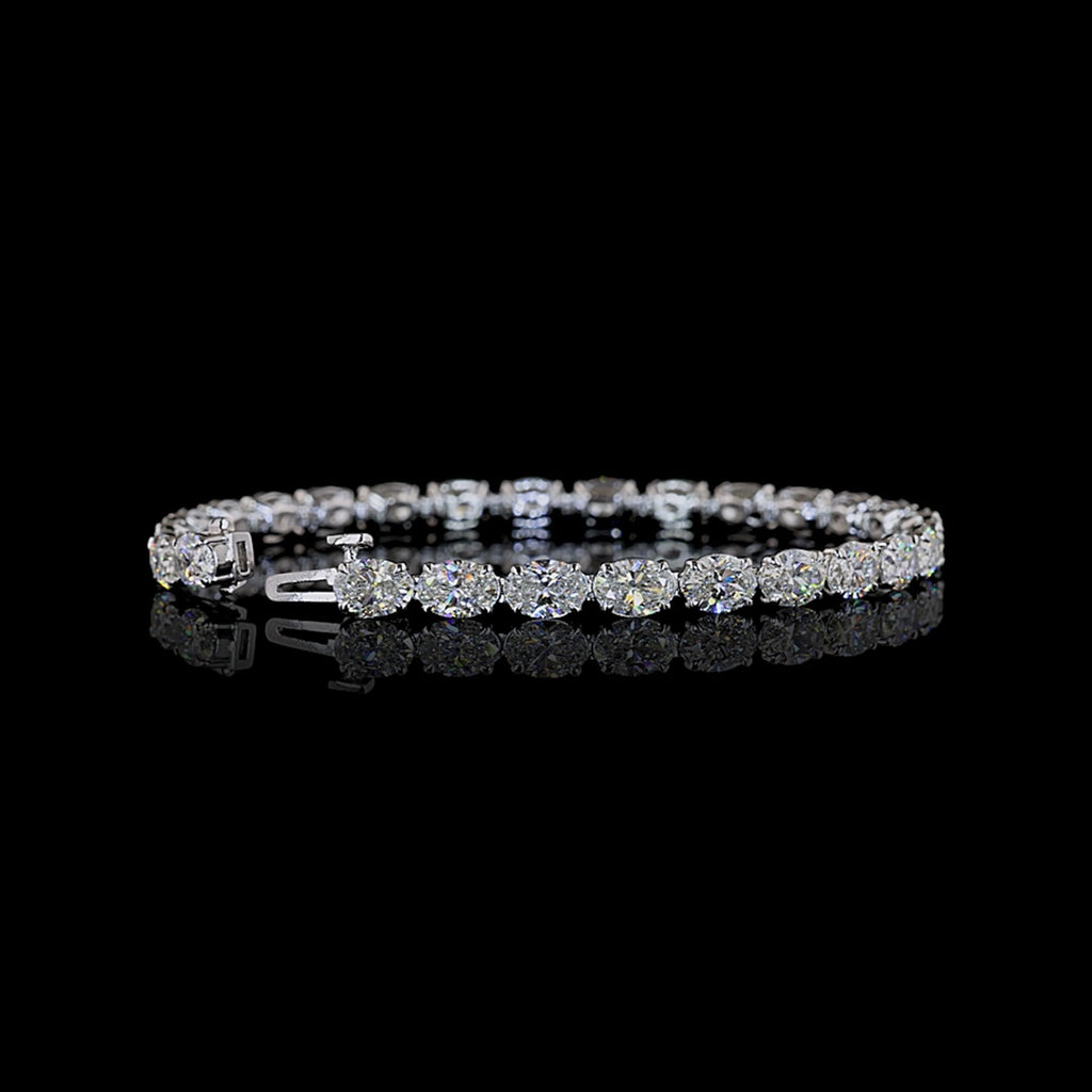 Video of East-West oval lab grown diamond tennis bracelet, 50-pointer (half carat each) diamonds in a claw prong setting, 12 carats total. 