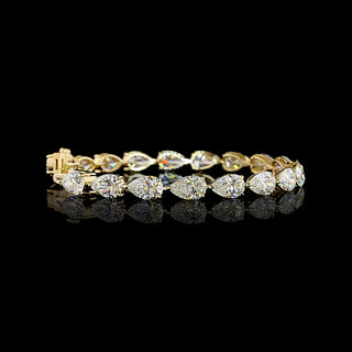 Video of East-West Pear-shaped lab grown diamond tennis bracelet in 14k yellow gold, with 1 carat each diamonds in a claw prong setting.