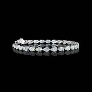 Video of East-West Pear-shaped lab grown diamond tennis bracelet in 14k white gold, prong setting, 8 carat total weight, with 30 to 33-pointer diamonds.