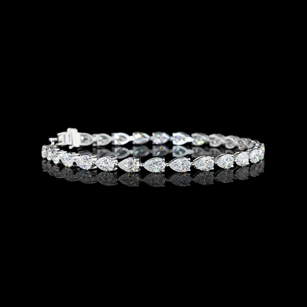 Video of East-West Pear-shaped lab grown diamond tennis bracelet in 14k white gold, prong setting, 8 carat total weight, with 30 to 33-pointer diamonds.