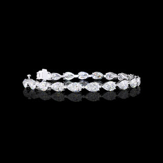 Video of east-west pear shaped lab grown diamond tennis bracelet in 14k white gold, with 70-pointer pear diamonds in a prong setting, 14 carats total.