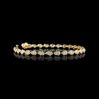 Video of East-West Pear-shaped lab grown diamond tennis bracelet in 14k yellow gold bezel setting, 4 carats total, with 15-pointer diamonds.