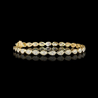 Video of East-West Pear-shaped lab grown diamond tennis bracelet in 14k yellow gold bezel setting, 6 carats total, with 20-pointer diamonds.