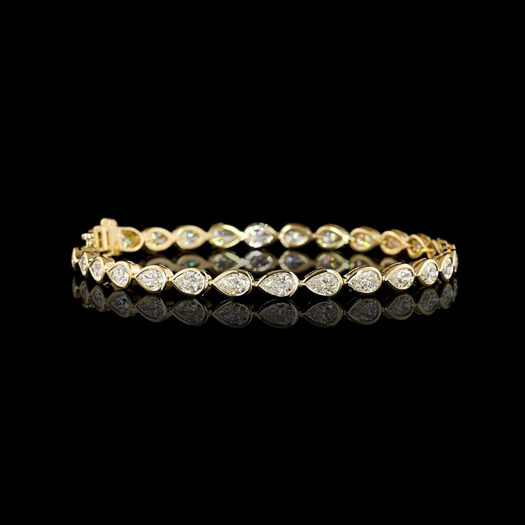 Video of East-West Pear-shaped lab grown diamond tennis bracelet in 14k yellow gold bezel setting, 6 carats total, with 20-pointer diamonds.