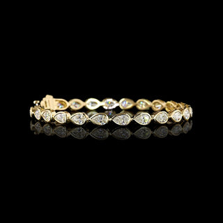 Video of East-West Pear-shaped lab grown diamond tennis bracelet in 14k yellow gold bezel setting, 8 carats total, with 33-pointer diamonds.