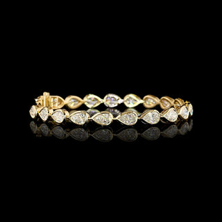 Video of East-West Pear-shaped lab grown diamond tennis bracelet in 14k yellow gold bezel setting, 10 carats total, with 50-pointer (half carat) diamonds.