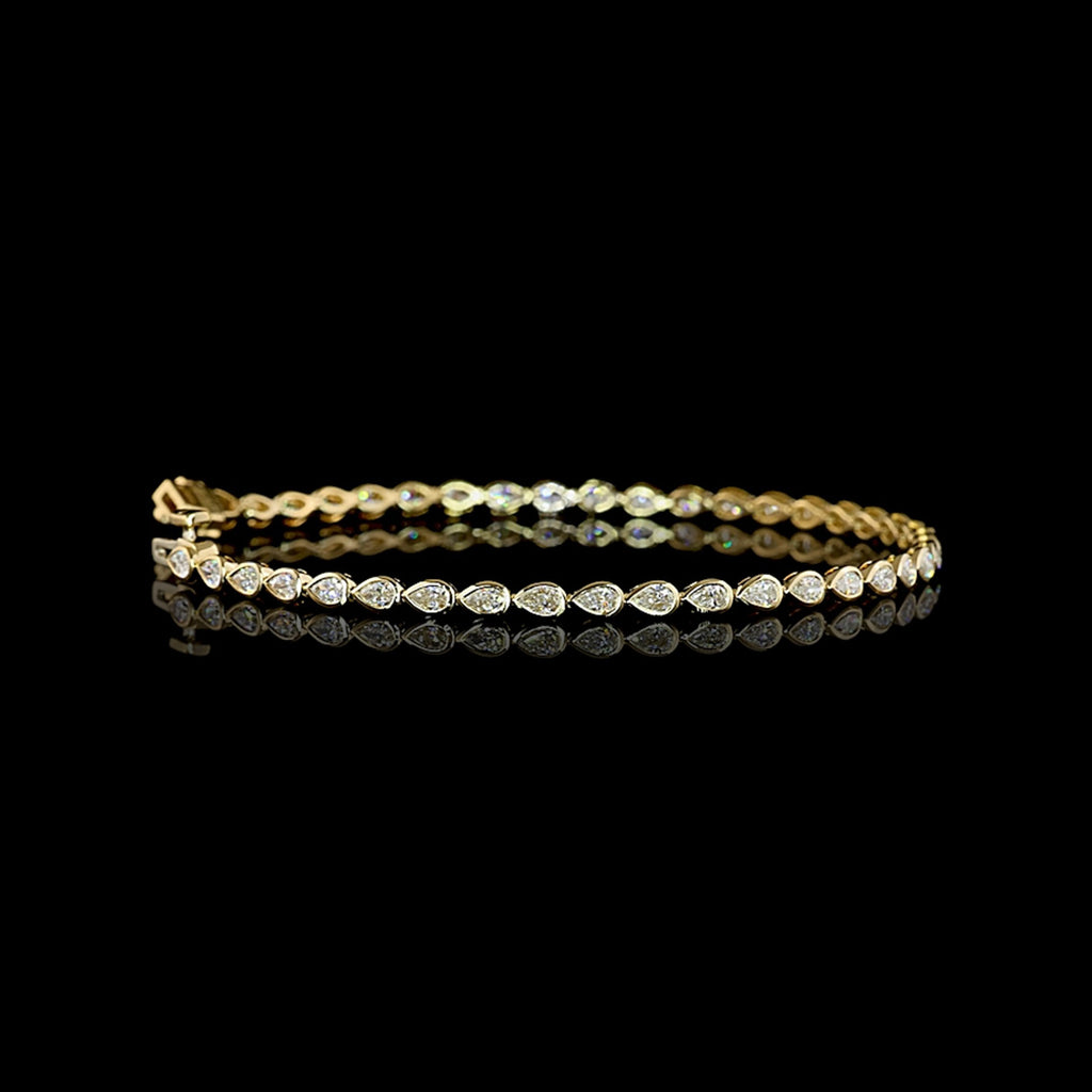 Video of East-West Pear-shaped lab grown diamond tennis bracelet in 14k yellow gold bezel setting, 2 carats total, with 5-pointer diamonds.